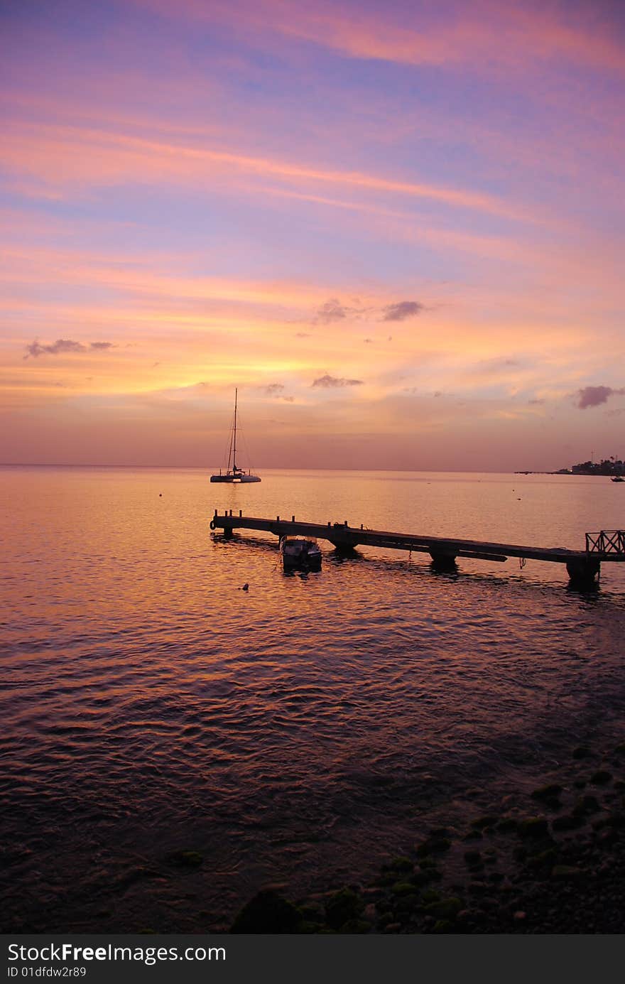 Tropical sunset with pier and boat. Tropical sunset with pier and boat