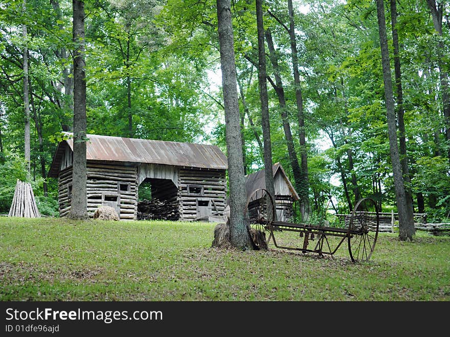 A weathered old barn surrounded by trees. A weathered old barn surrounded by trees.