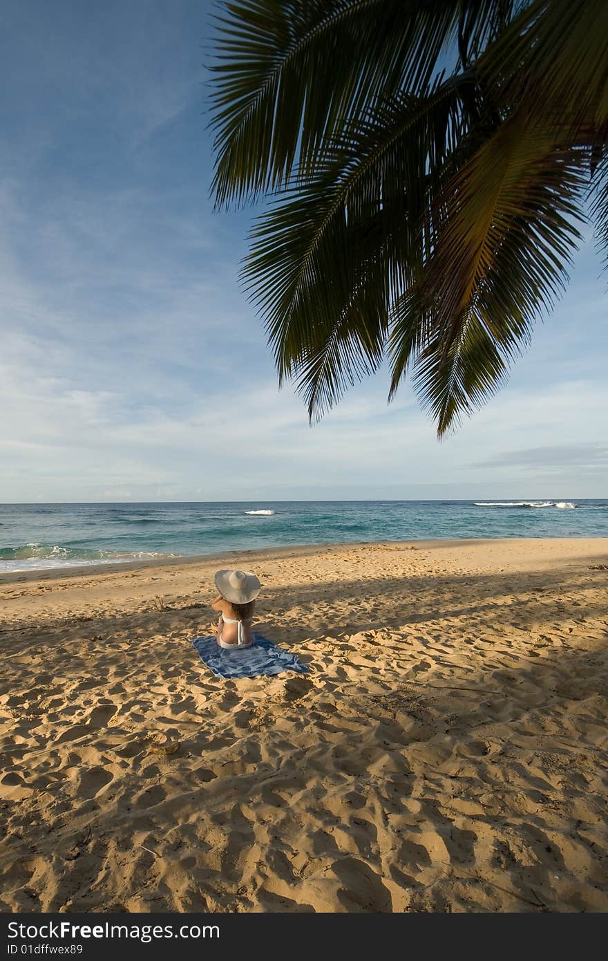 Girl sitting on the beach in Dominican republic