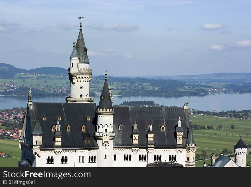 Neuschwanstein castle in autumn on a clear sunny day with lake and city visible, Bavaria Germany. Neuschwanstein castle in autumn on a clear sunny day with lake and city visible, Bavaria Germany