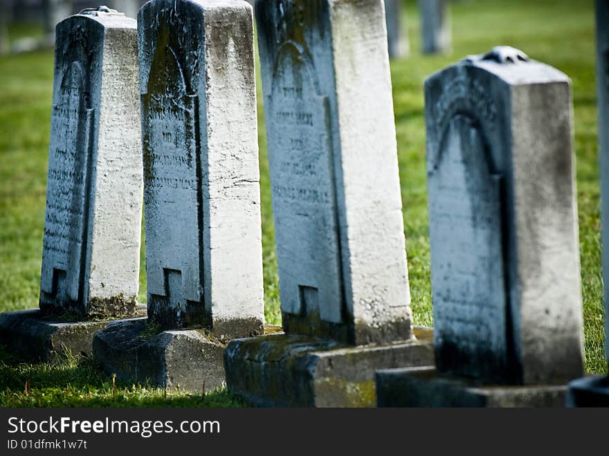 A group of old weathered carved gravestones