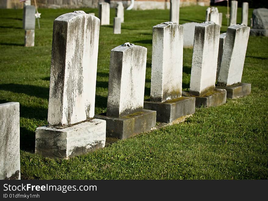 A group of old weathered blank gravestones