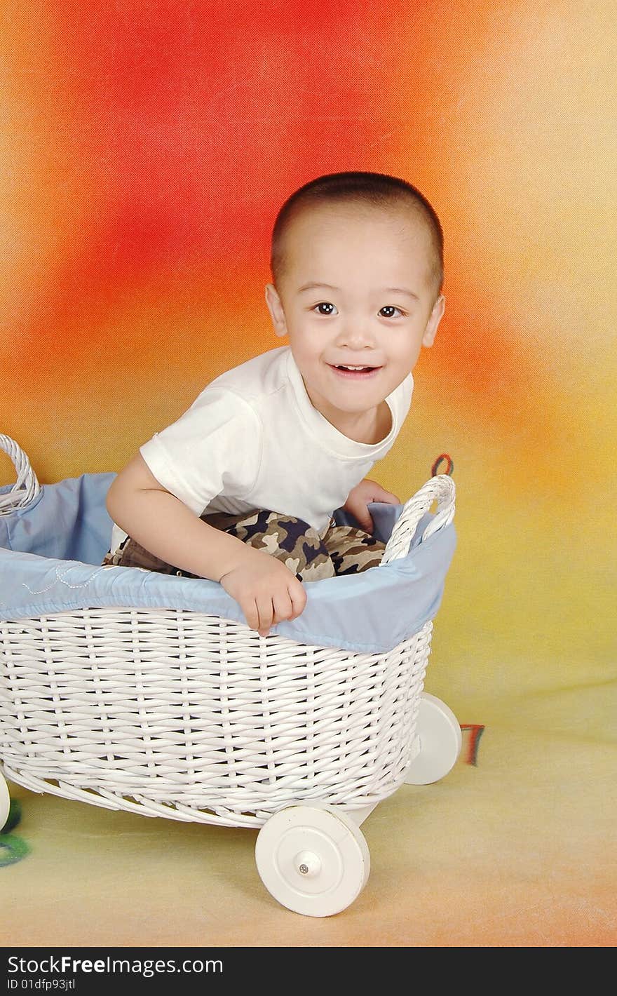 There is a boy sitting in the toy car,he is very happy. There is a boy sitting in the toy car,he is very happy.