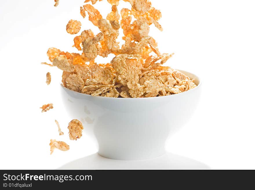 Bowl of cereal with raisins, milk and orange juice