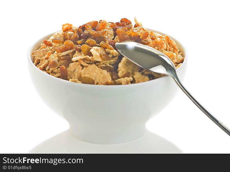 Bowl of cereal with raisins, milk and orange juice