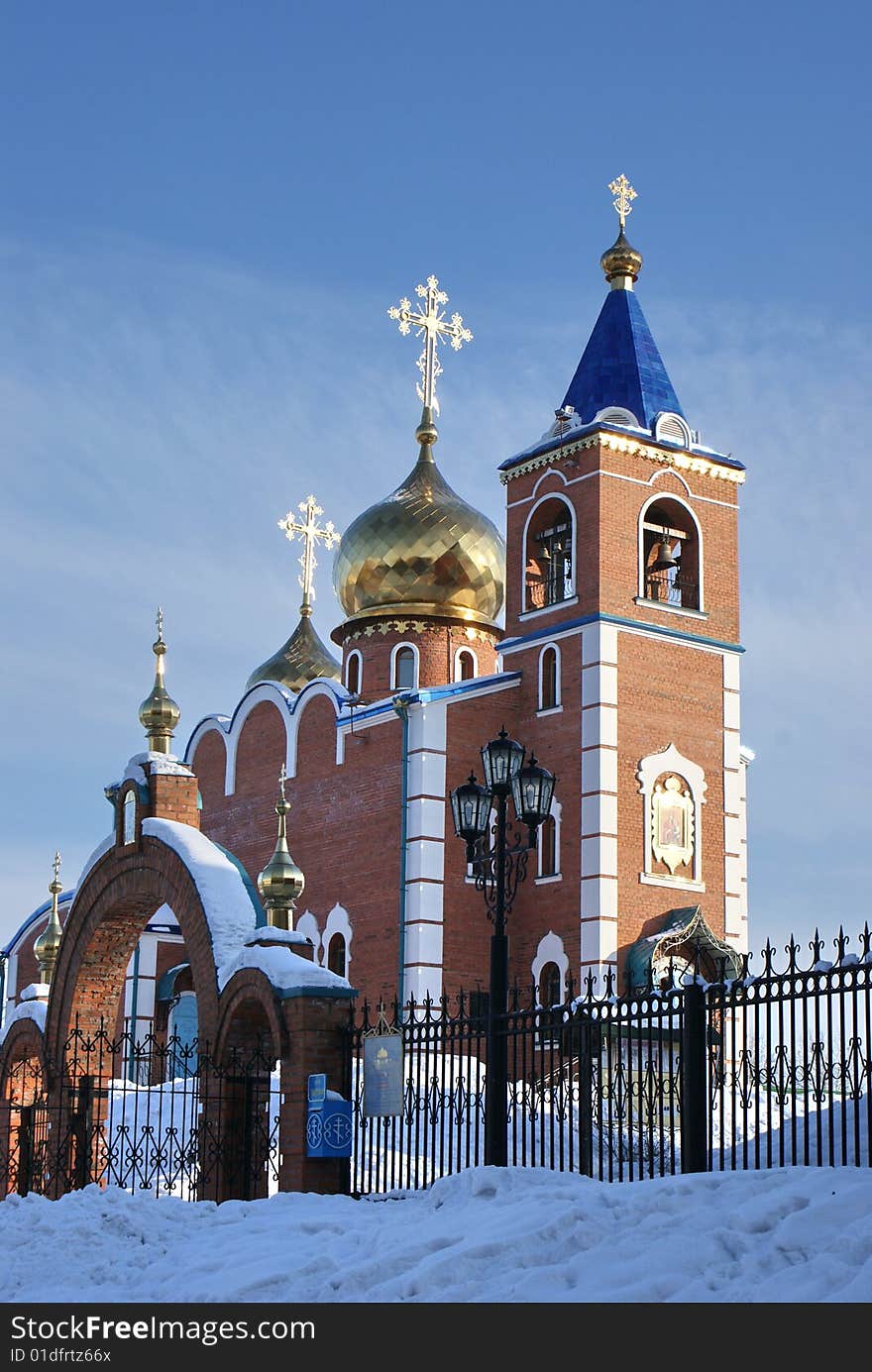 Church costing at top of a hill on a background of the dark blue sky