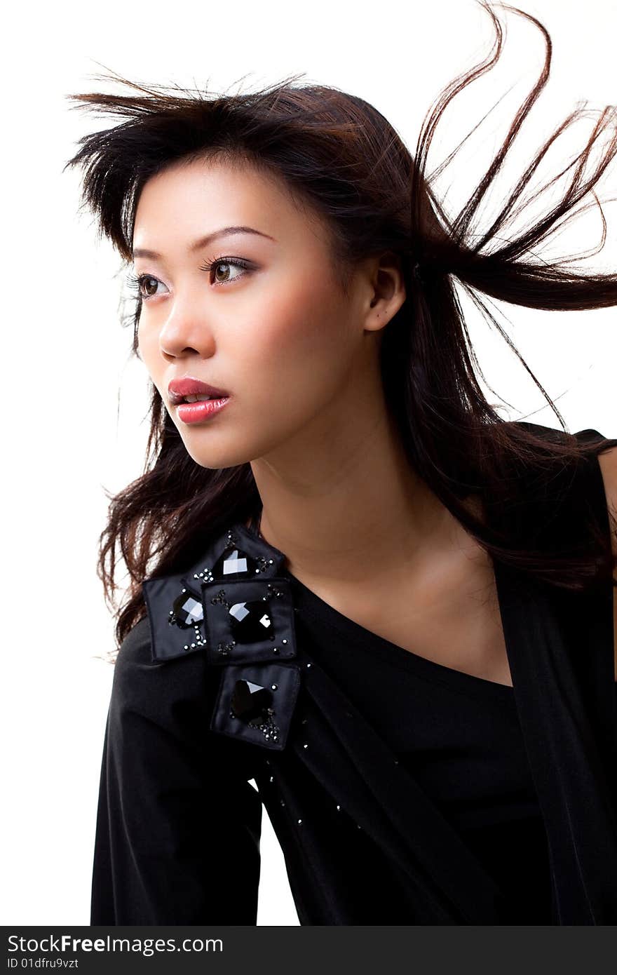 Young asian woman in black with wind blowing in her hair. Young asian woman in black with wind blowing in her hair