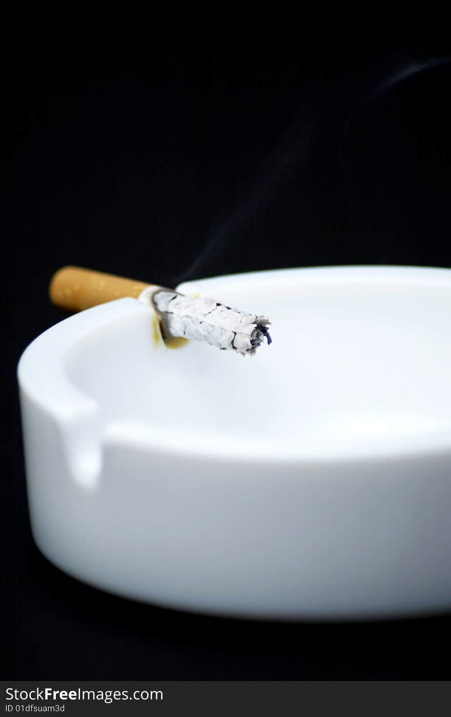 Cigarette butt in ashtray - No smoking