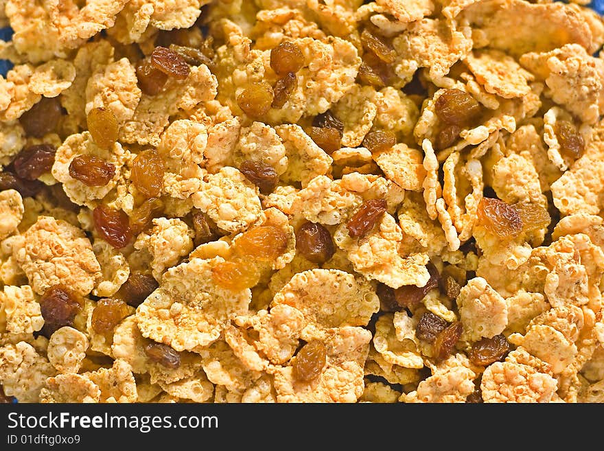 Bowl of cereal with raisins, milk and orange juice