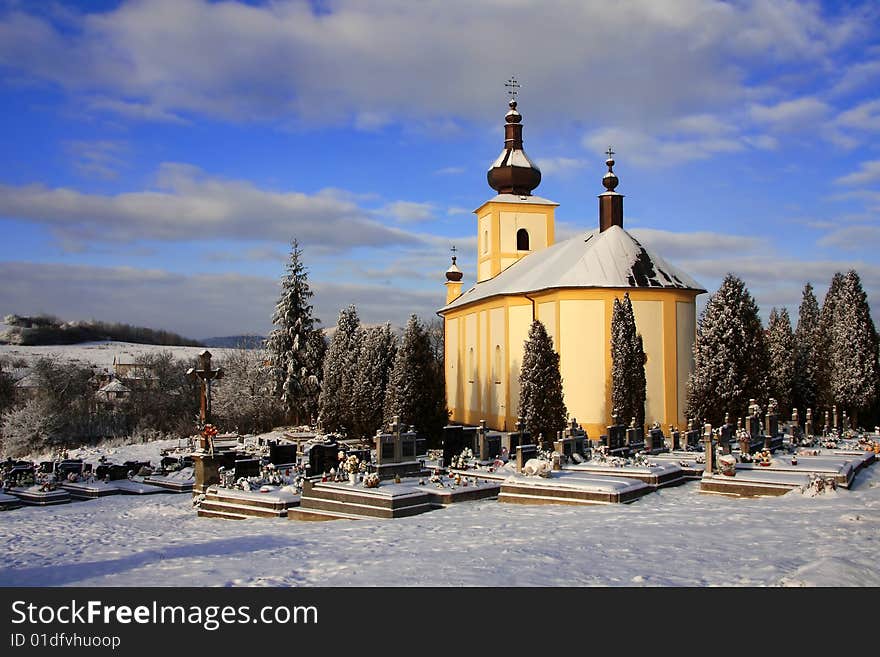 The old church with cemetery in the winter