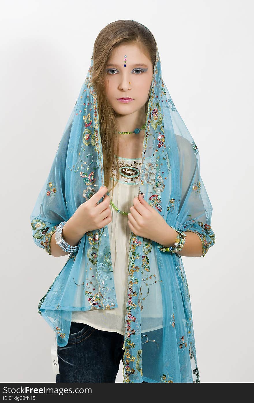 Fashion girl showing jewelry and blue scarf. Fashion girl showing jewelry and blue scarf