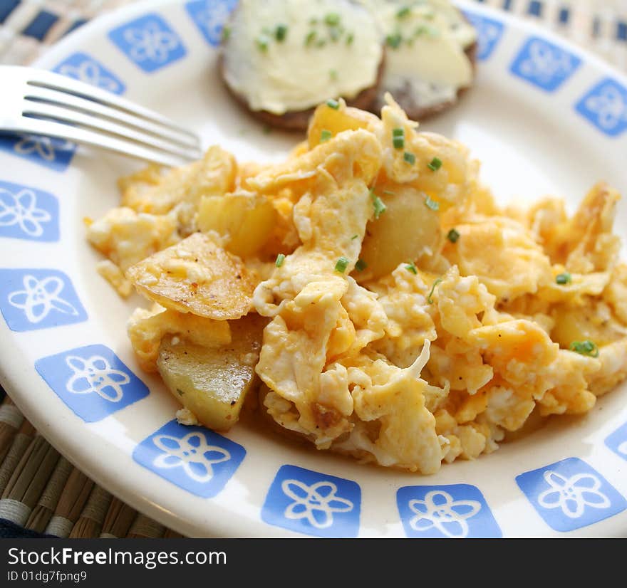 A meal of potatoes with eggs and bread