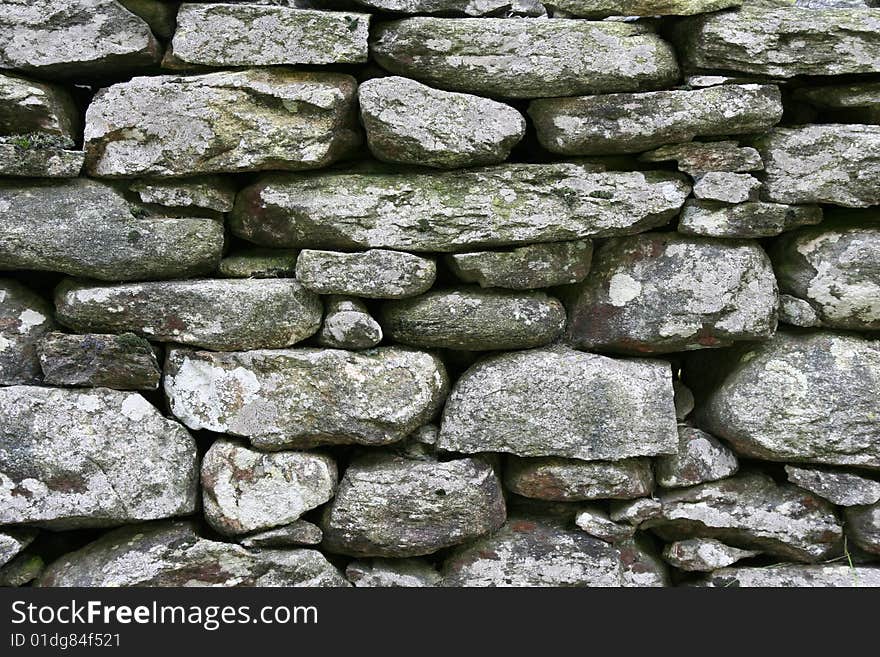 Old stoned wall as background. Old stoned wall as background