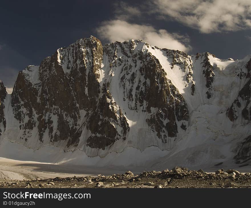 Mountains. Clouds, blue sky. Ice. Mountains. Clouds, blue sky. Ice