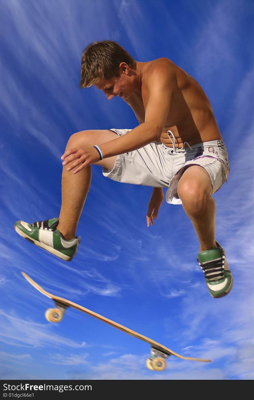 Boy with skateboard against a blue sky with clouds. Boy with skateboard against a blue sky with clouds