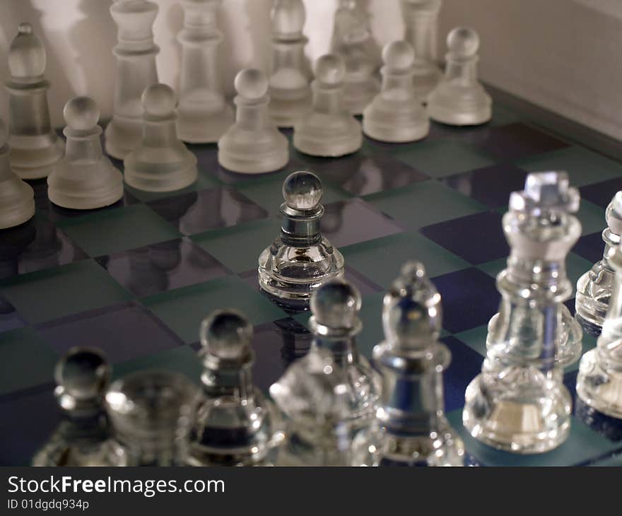 Glass chess on the glass chessboard