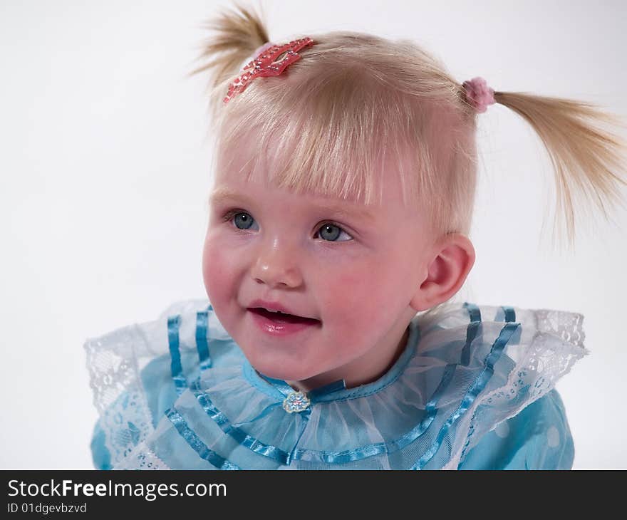 Child in blue gown smiles. Child in blue gown smiles