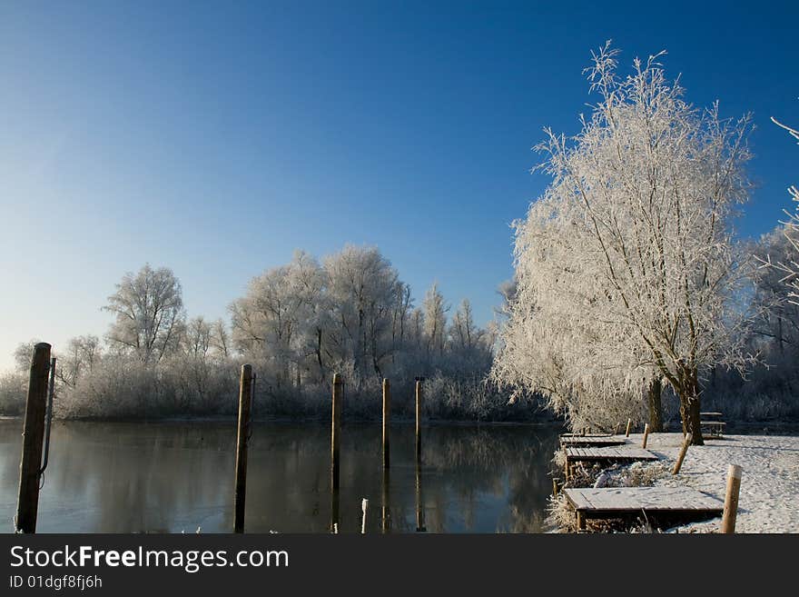 Winter scenery with some poles in a lake