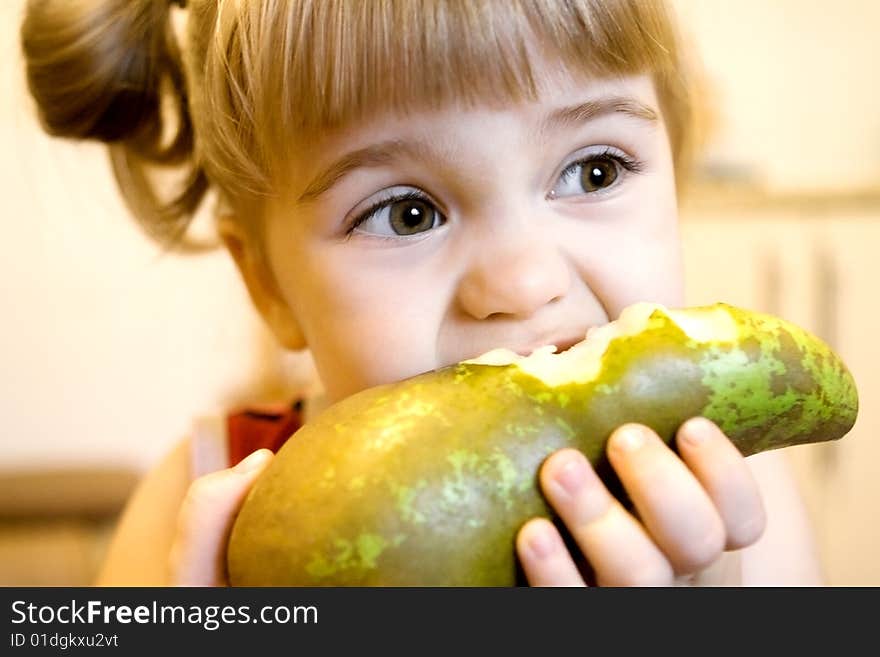 Portrait of the little girl biting the big green pear. Portrait of the little girl biting the big green pear.