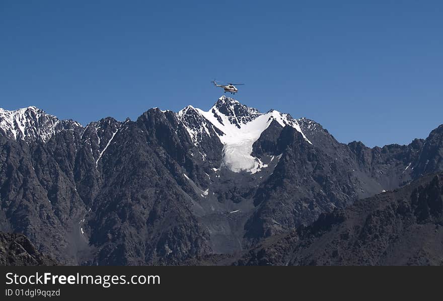 Helicopter in the mountains, sky