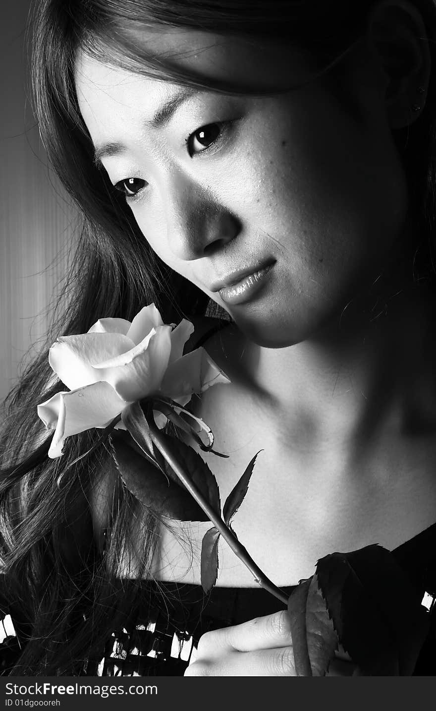 Black and White photograph of a japanese woman holding a rose. Black and White photograph of a japanese woman holding a rose.