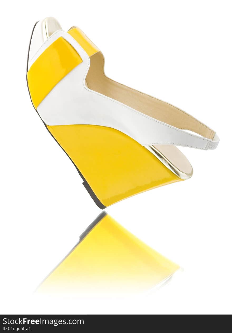 Yellow shoe on white with reflrction. Yellow shoe on white with reflrction