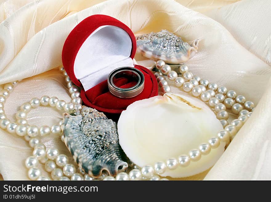 Wedding rings and shell and pearl