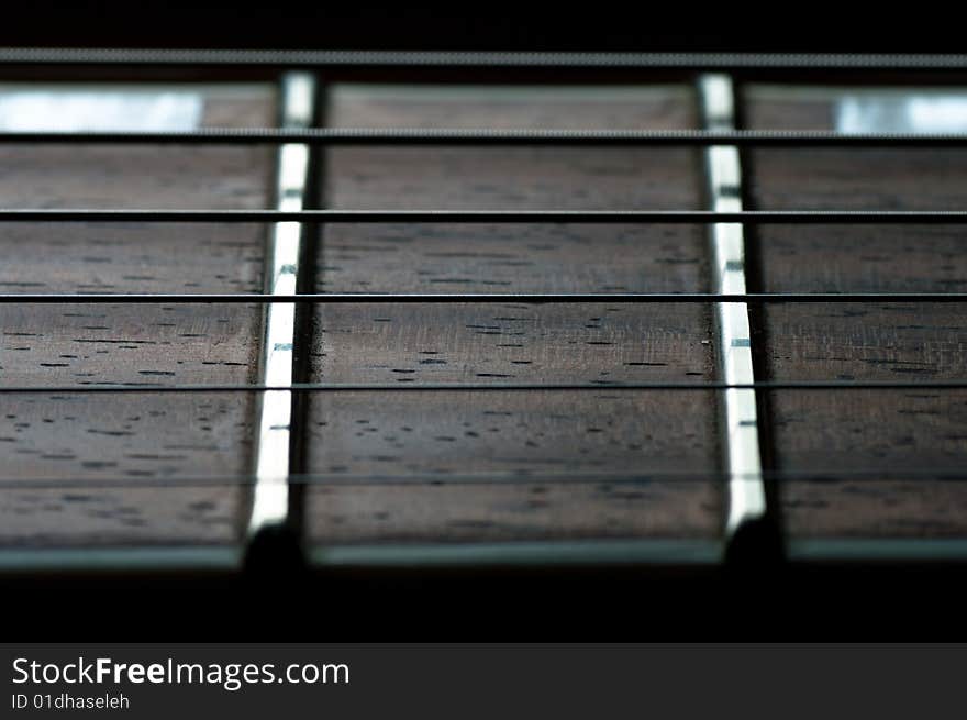 Extreme close-up of guitar neck fretboard and strings. Extreme close-up of guitar neck fretboard and strings