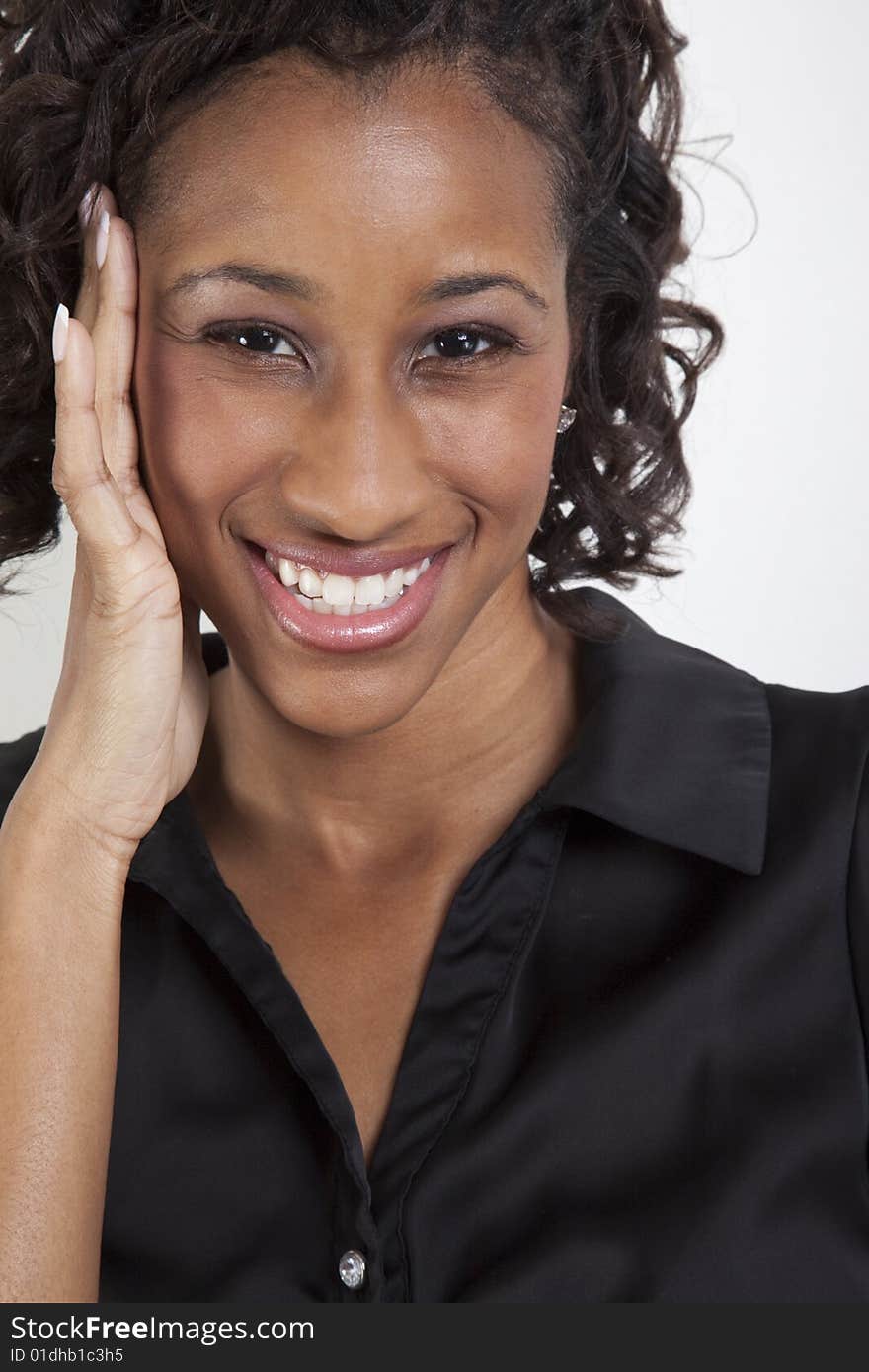 Portrait of a very happy african descent woman with her hand touching her face. Portrait of a very happy african descent woman with her hand touching her face