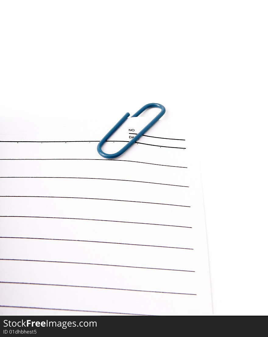 Sheet of notepad with blue paperclip on a white background. Sheet of notepad with blue paperclip on a white background