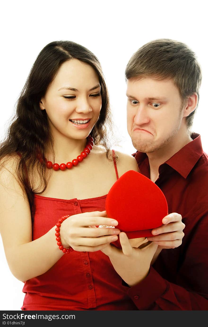 Surprised young couple opening a present isolated against white background