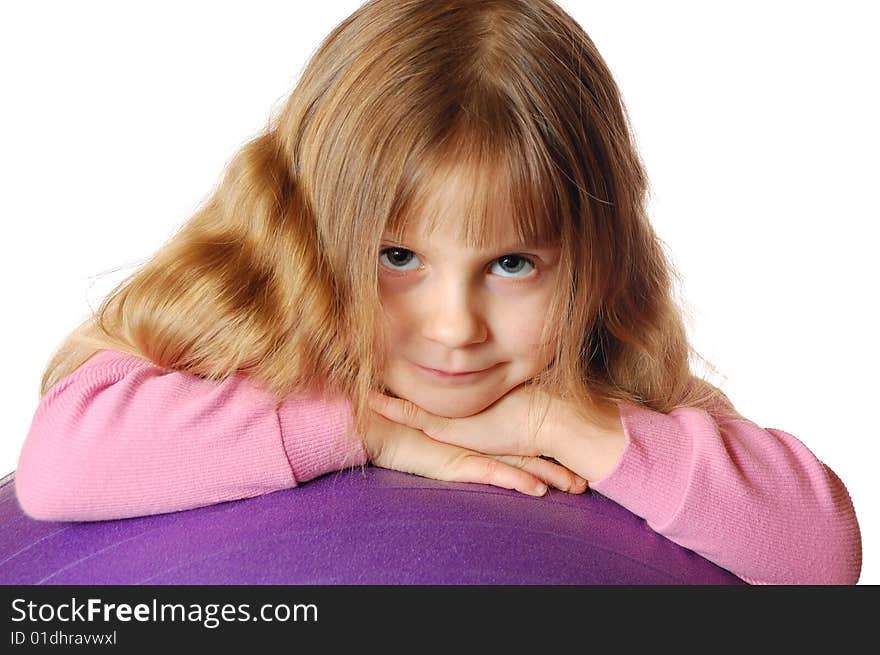 A 4 year old girl with a big violet ball. A 4 year old girl with a big violet ball