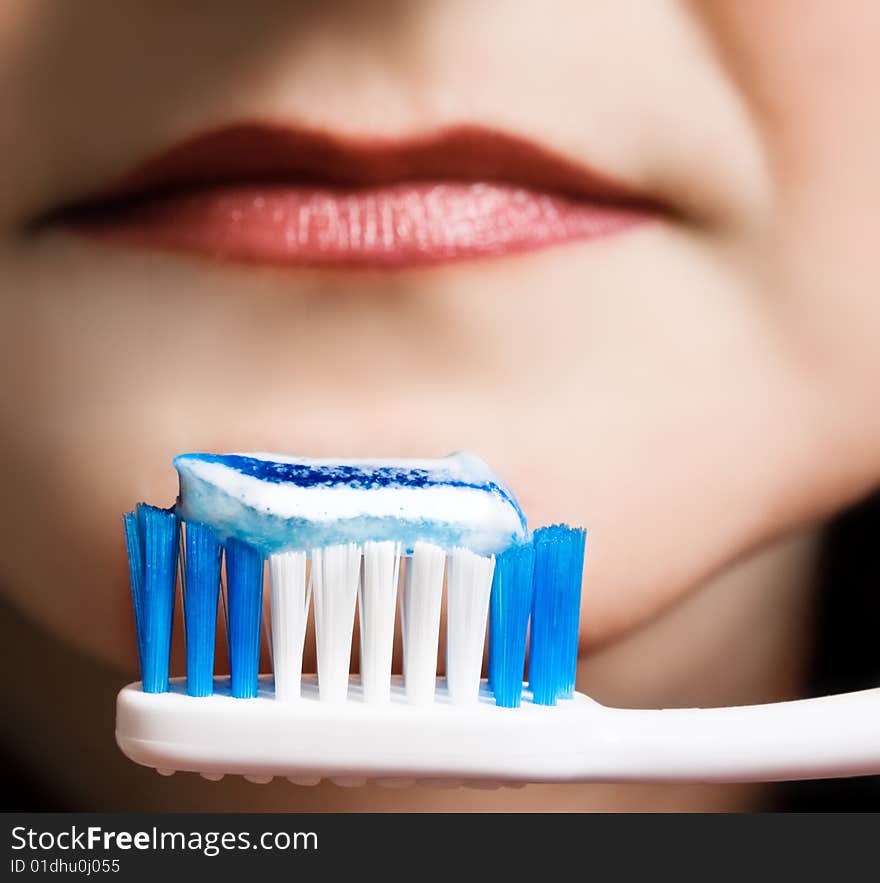 A young girl with a toothbrush. A young girl with a toothbrush