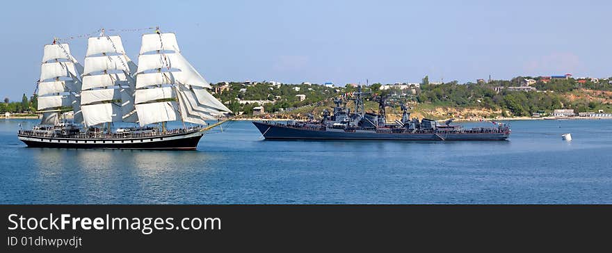 Sailfish and warship in harbour. Sailfish and warship in harbour