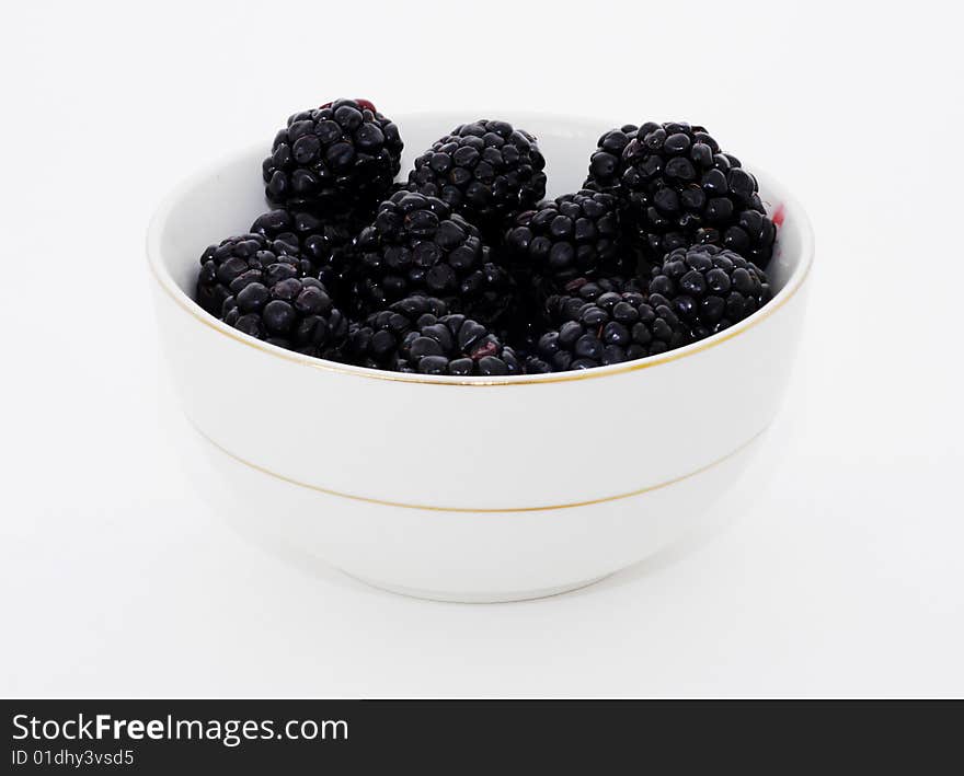 A bowl of fresh blackberries, isolated on white. A bowl of fresh blackberries, isolated on white