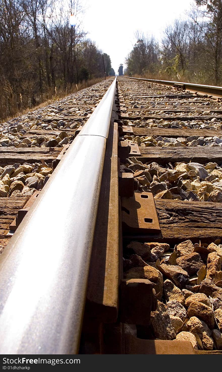 Looking down the rail of a railroad track.  Cross ties and gravel are visible. Looking down the rail of a railroad track.  Cross ties and gravel are visible.