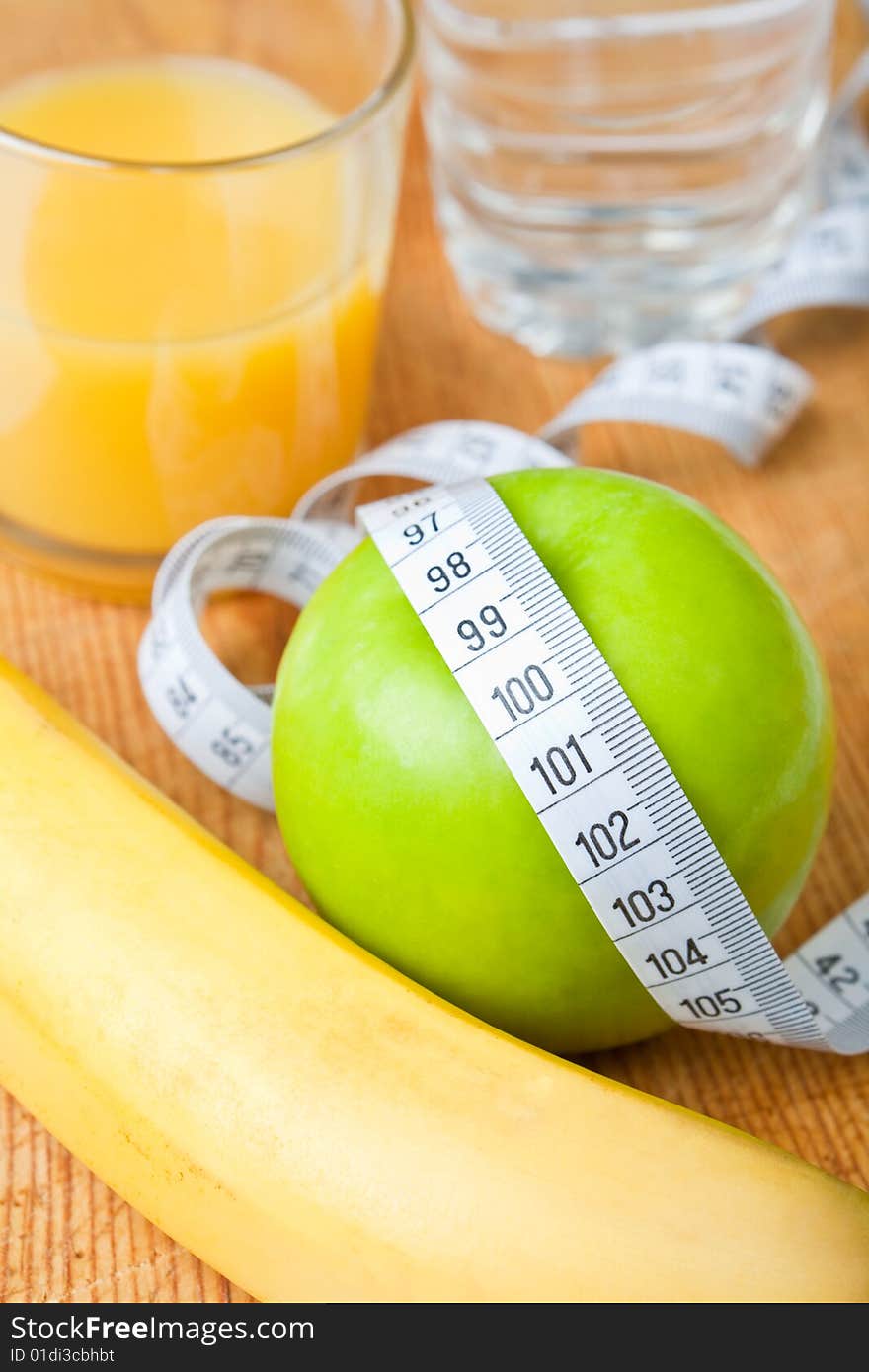 Refreshing healthy snack with an apple, banana and a glass of orange juice