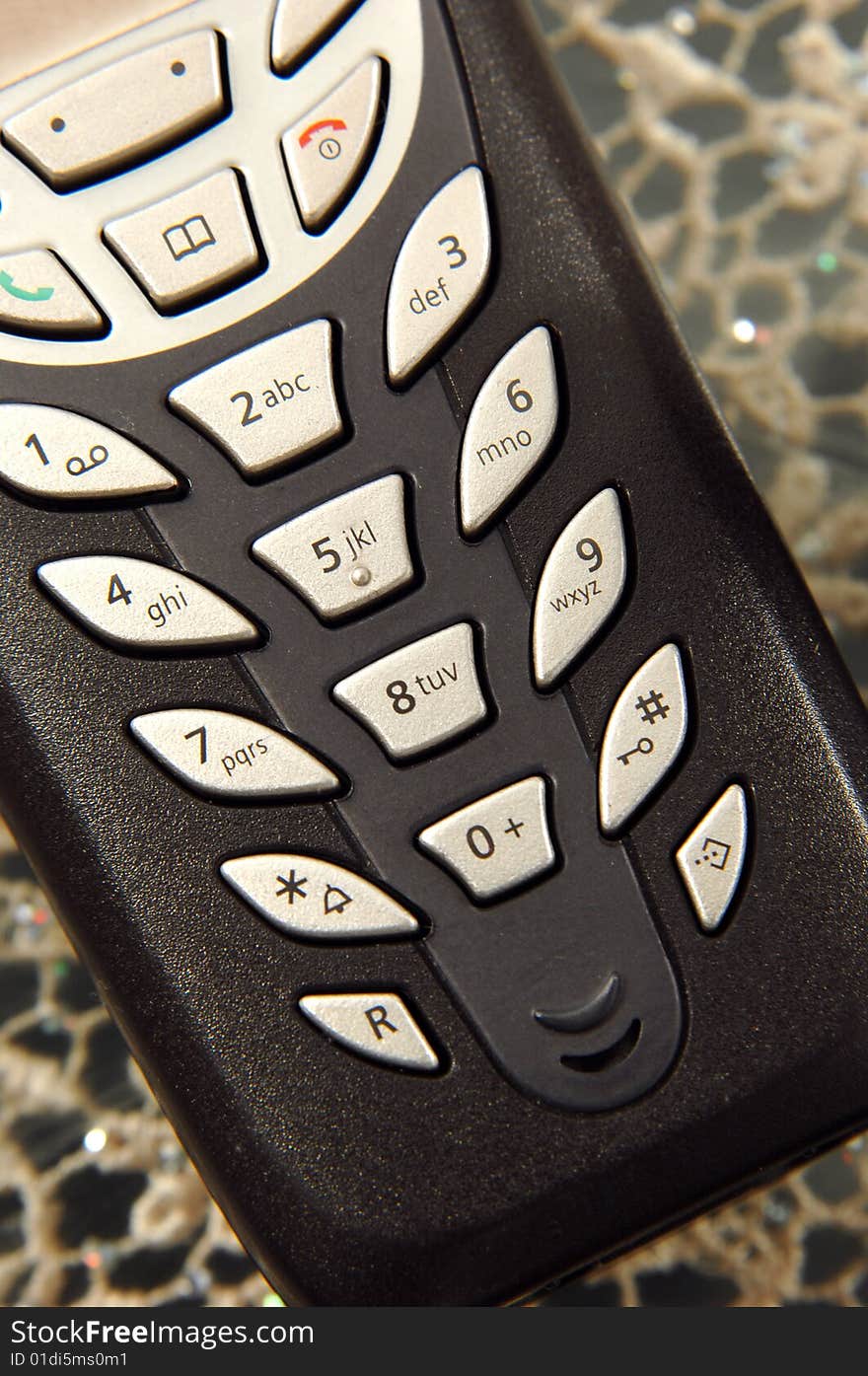 Cordless phone buttons detail on table. Cordless phone buttons detail on table