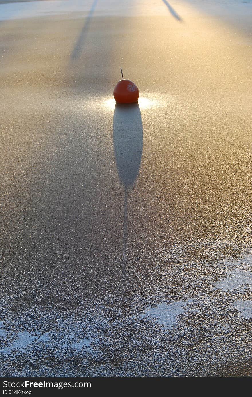 Small frozen buoy, reminding sun-dial. Small frozen buoy, reminding sun-dial.