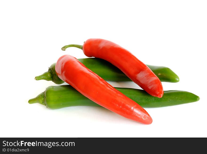 Red and green hot chili peppers isolated on white