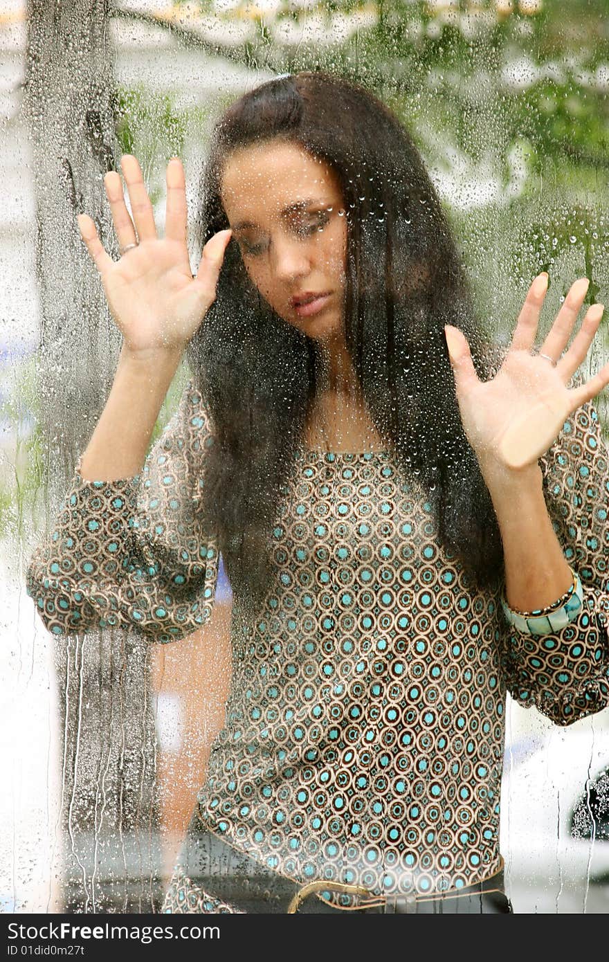 Young woman on the wet glass. Young woman on the wet glass