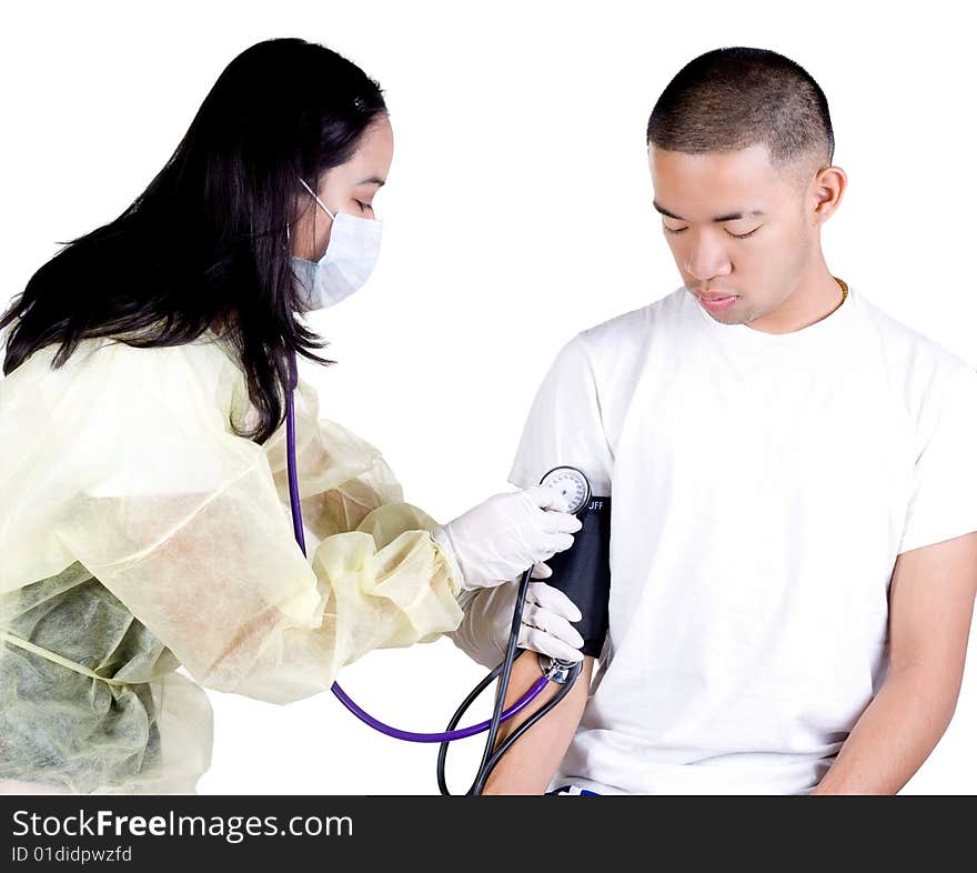 The nurse is checking the patients blood pressure. The nurse is checking the patients blood pressure