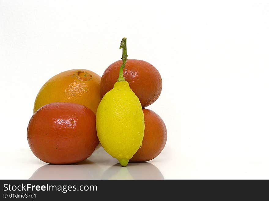 One Orange, one Lemon and three Clementines isoleted over a white backgroud. One Orange, one Lemon and three Clementines isoleted over a white backgroud