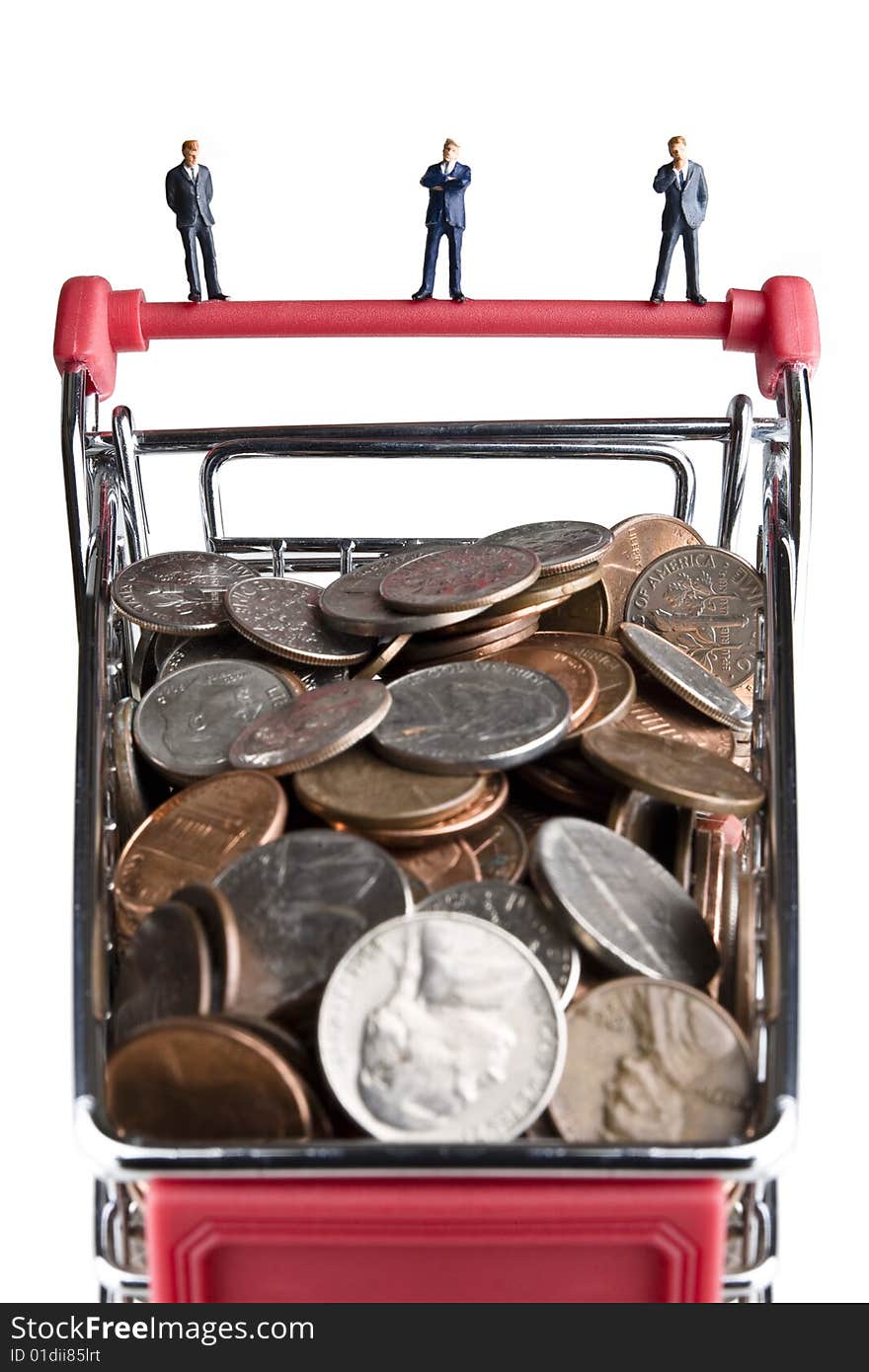 Businessman figurines standing on a shopping cart filled with coins. Businessman figurines standing on a shopping cart filled with coins