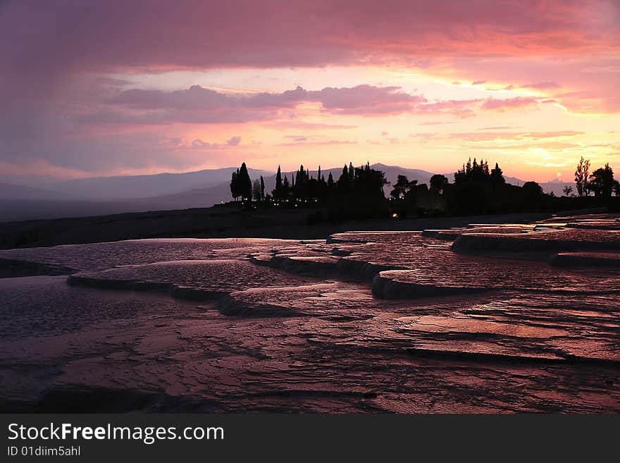 Travertines at Pamukkale at the sunset vibrant colors. Travertines at Pamukkale at the sunset vibrant colors