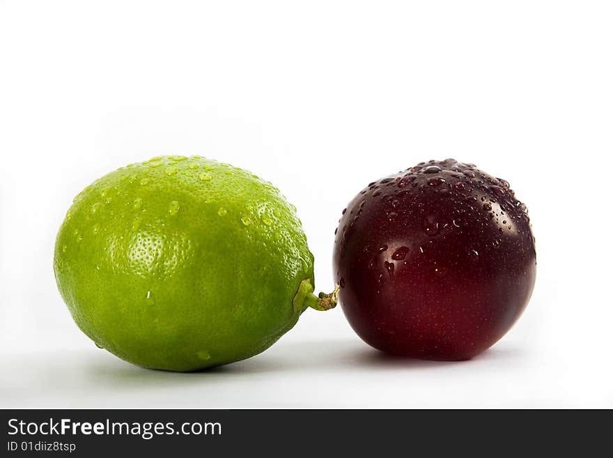 Lemon and plum on white background