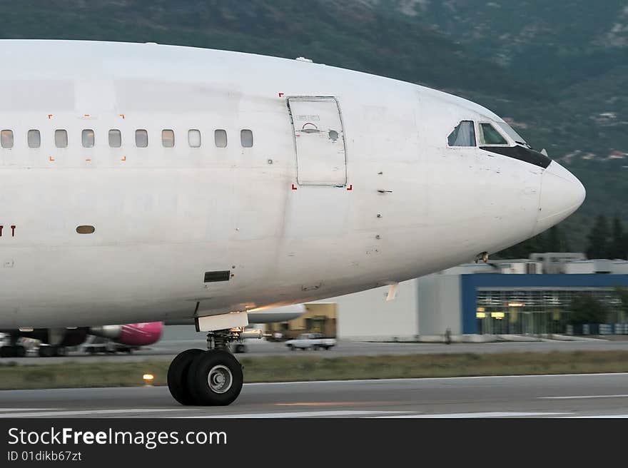 Wide-body passenger airplane is taxiing prior to departure. Wide-body passenger airplane is taxiing prior to departure