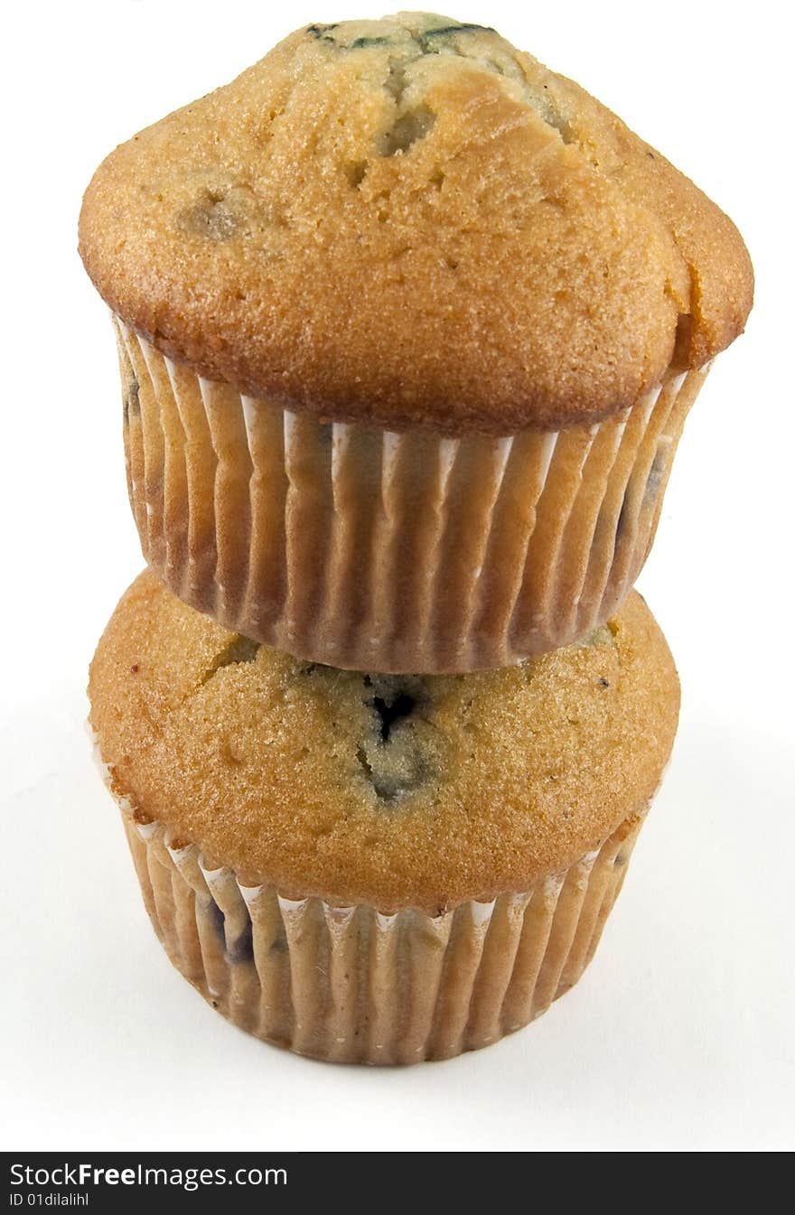 Two blueberry muffins stacked and isolated on white. Two blueberry muffins stacked and isolated on white.