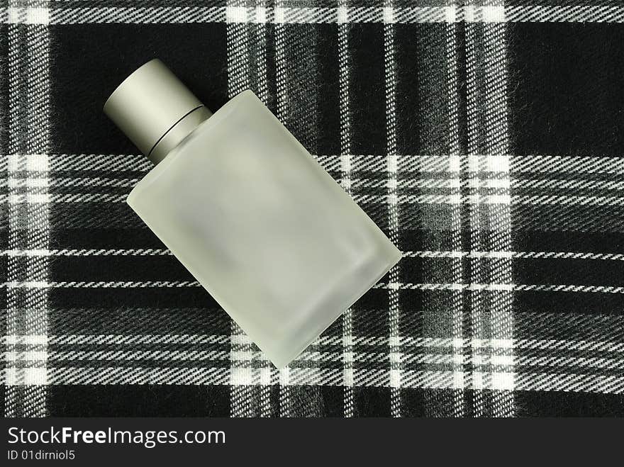 Perfume bottle on check pattern