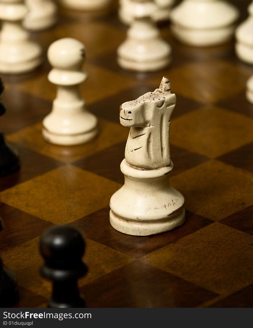 Worn knight on a chess board